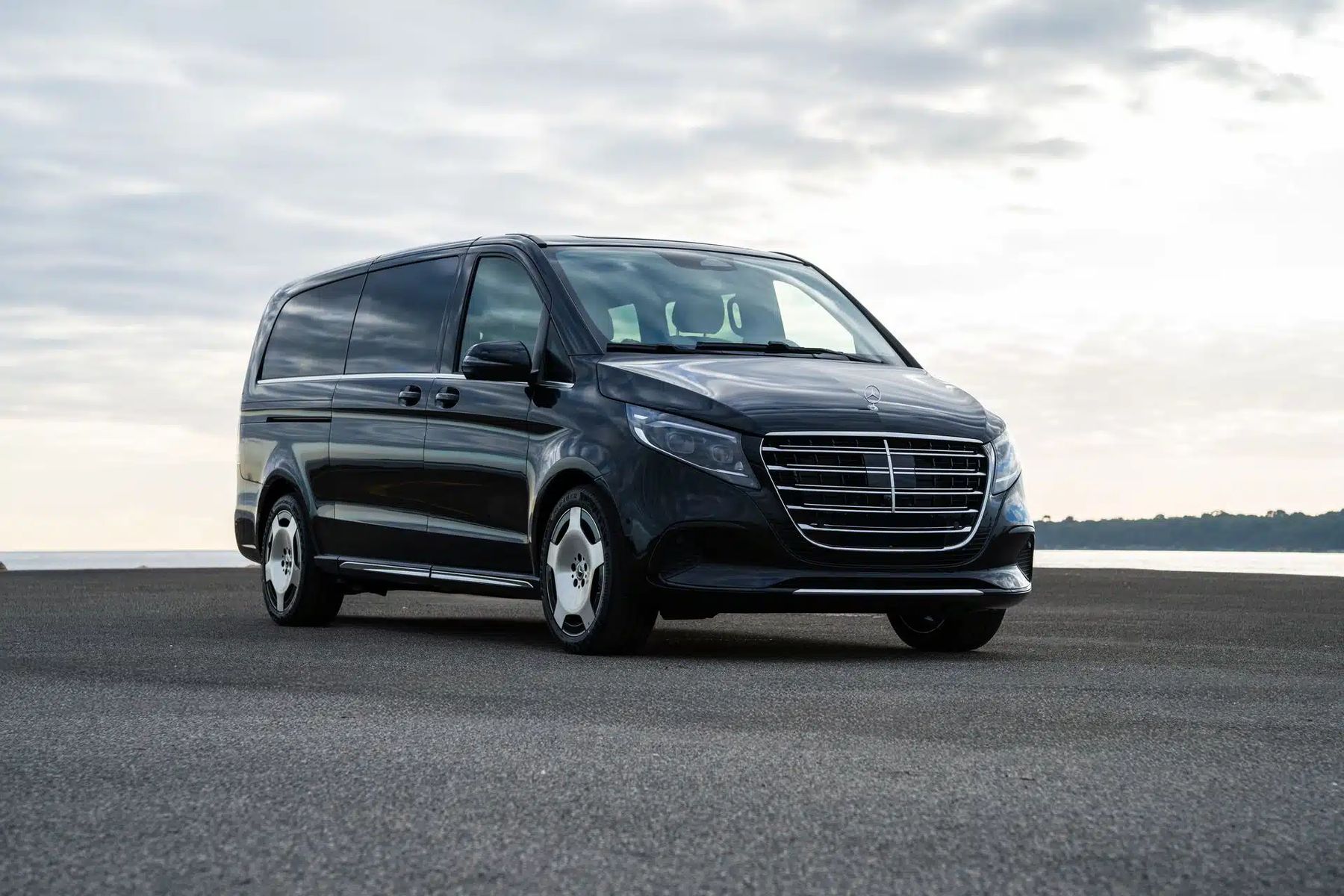 Black Mercedes V-Class parked by the water